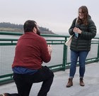 Photo of person on one knee proposing to another