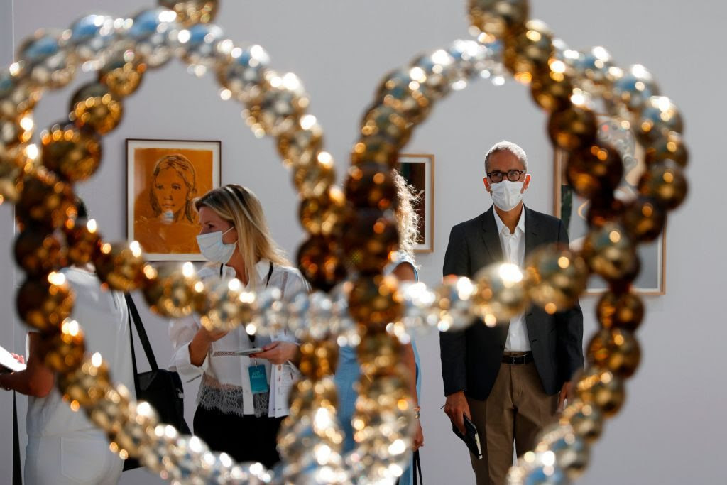Visitors look at the sculpture