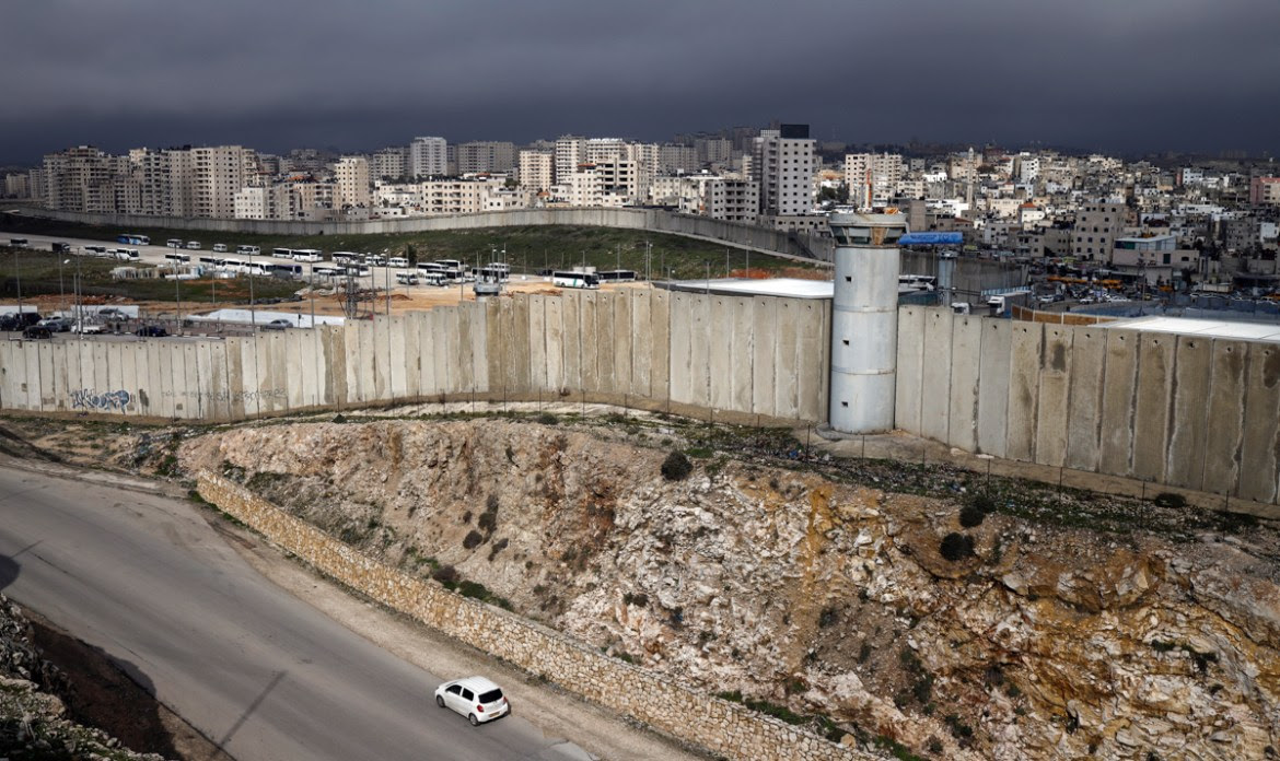 The Israeli separation barrier divides East Jerusalem and the Palestinian West Bank town of Qalandia. [File: Thomas Coex/AFP]