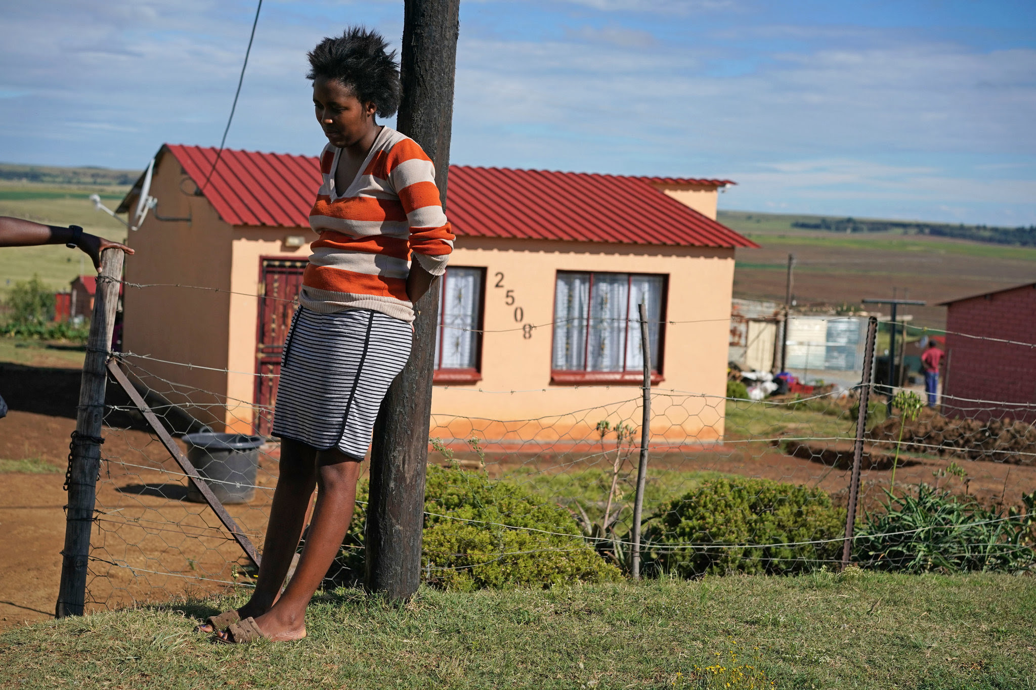 Andisiwe Mlaba outside her home in Warden. Her father, Vusi Mlaba, a member of the Democratic Alliance who spoke out against corruption in Free State, was gunned down nearby. Credit Joao Silva/The New York Times 