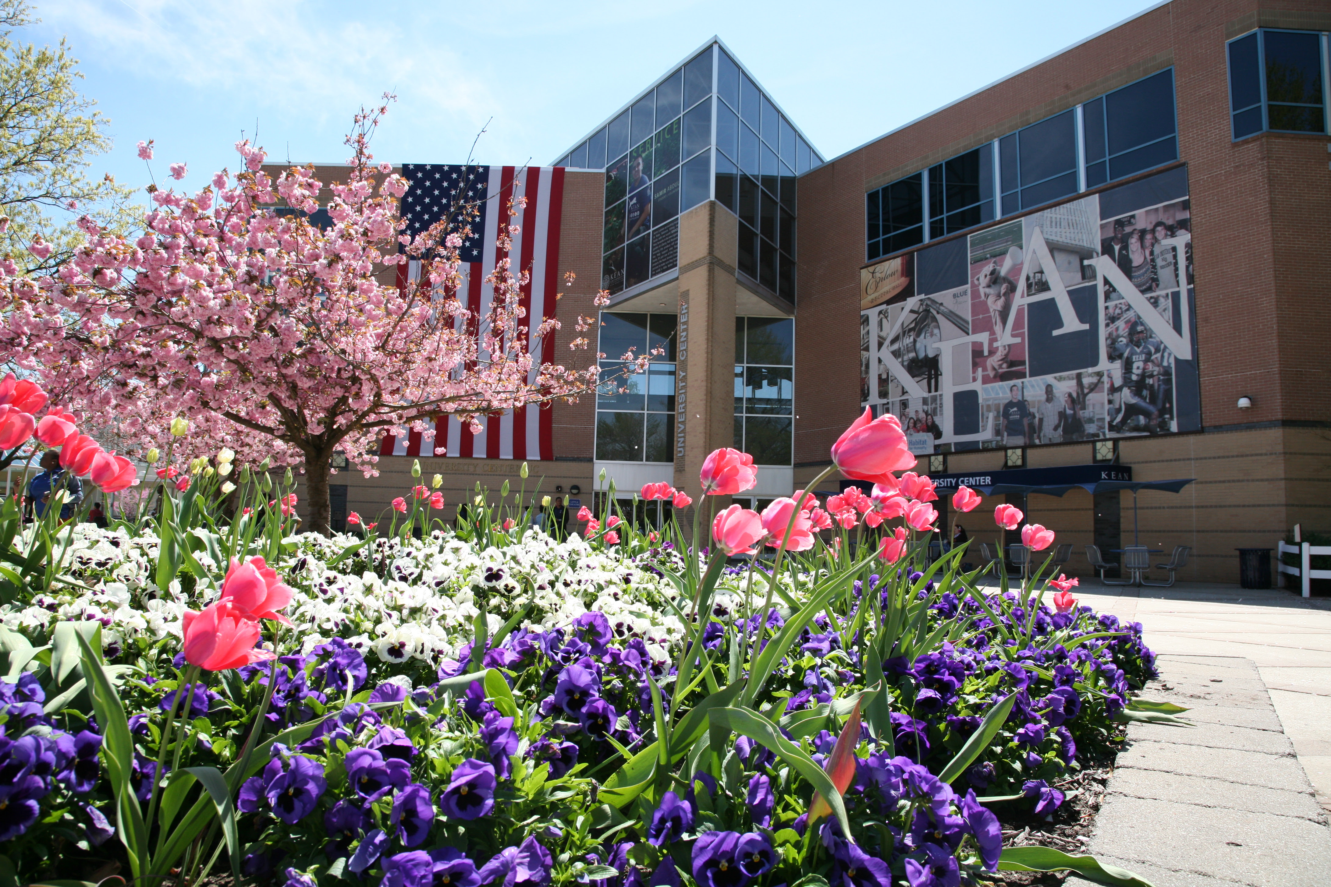 The Miron Student Center with blooming flowers on Kean's Union campus.