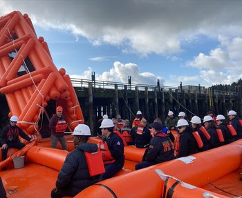 People in an emergency safety ship evacuation boat