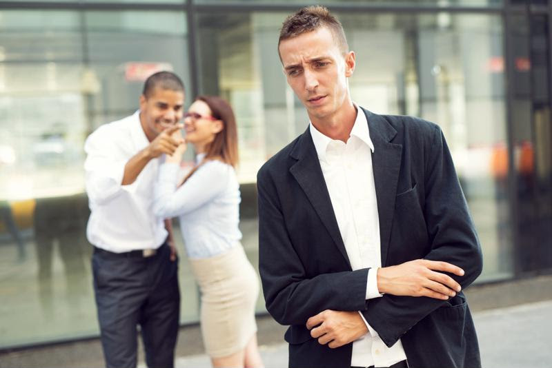 Photo of man being bullied by coworkers.