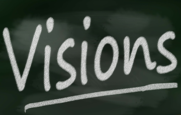 The word VISIONS written in chalk on a blackboard