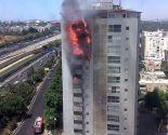 Flames shooting out of the building in Ramat Gan on Bialik Street appear to be spreading from one floor to the next, due in part to the hot, dry and windy weather conditions.