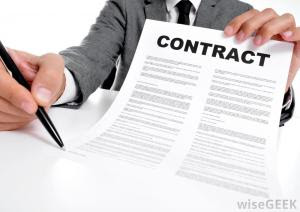 man-in-suit-holding-contract-and-pen