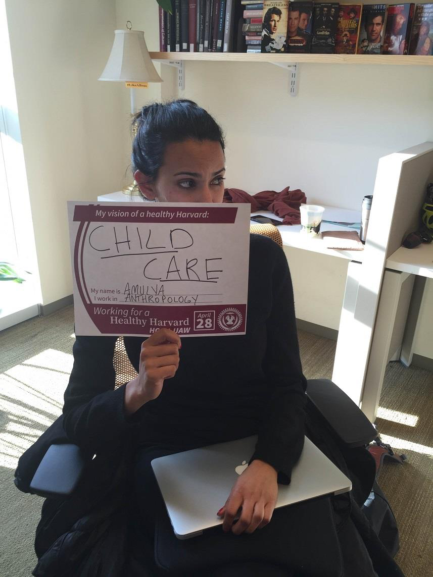 Photo of CEEC co-chair Amulya Mandava holding a better Harvard sign