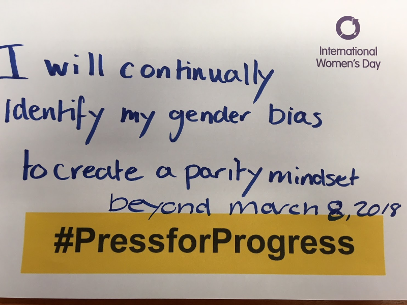 Photo of a handwritten statement reading 'I will continually identify with my gender bias to create a parity mindset beyond March 8, 2018' for International Women's Day