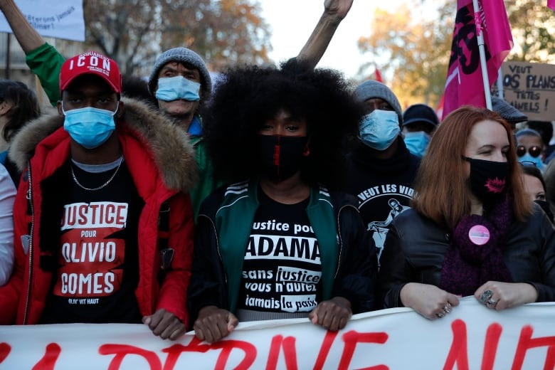 Assa Traore, centre, sister of Adama Traore attends a demonstration against a security law that would restrict sharing images of police on Nov. 28, 2020 in Paris. Adama Traore was a Black man killed in police custody in France, whose case has mobilized broad anger against police brutality and racial injustice. (Francois Mori/The Associated Press)