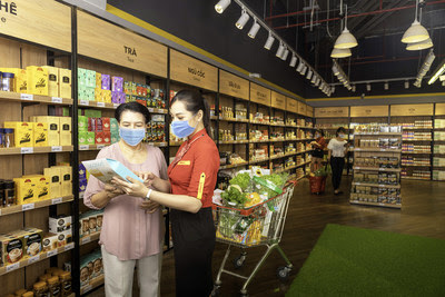 A customer selects products at a VinMart (now WinMart) supermarket operated by Masan Group