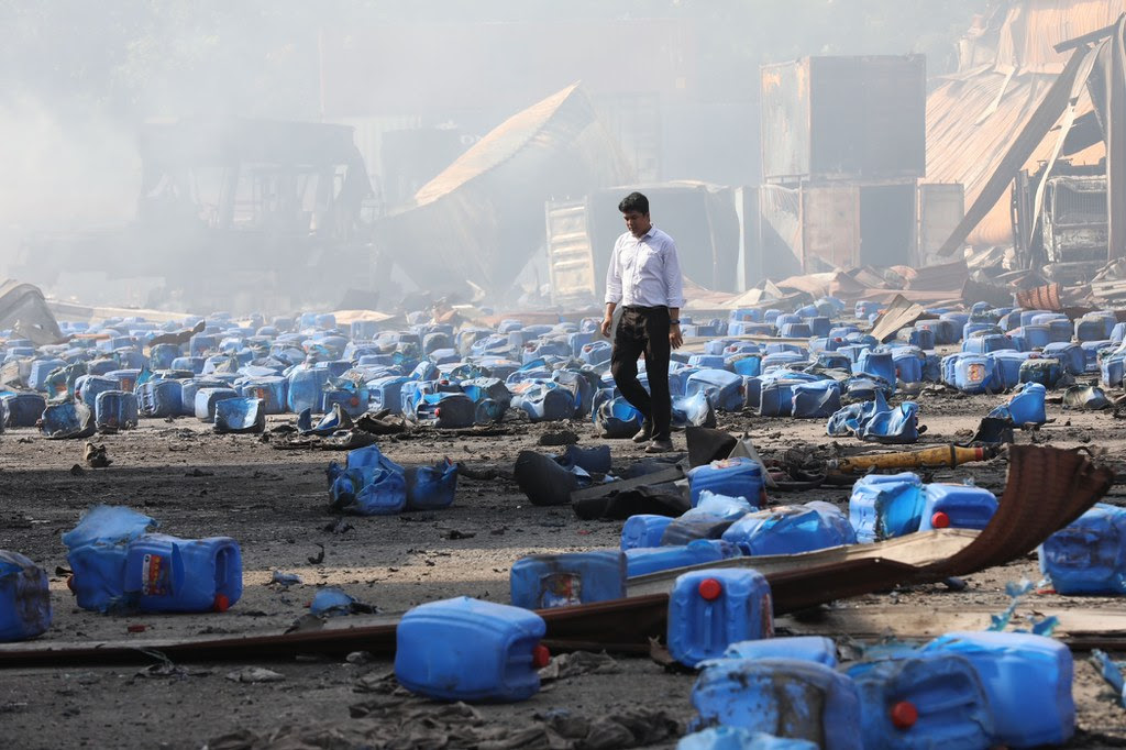 A man walks among debris scattered at the B.M. Container Depot in the Sitakunda sub-district of Chittagong, Bangladesh, two days after an explosion and fire claimed dozens of lives, June 6, 2022. [BenarNews]