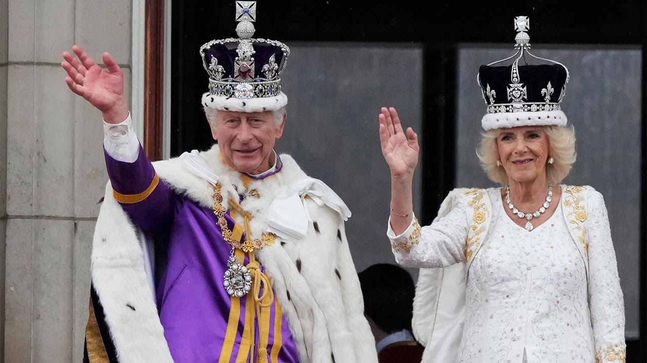 Britain's King Charles III and Queen Camilla wave to the crowds from the balcony of Buckingham Palace after the coronation ceremony in London, May 6, 2023.