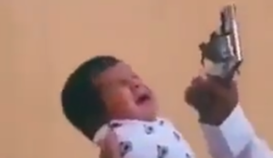 Video: Muslim father shoots gun around infant son to accustom him to jihad