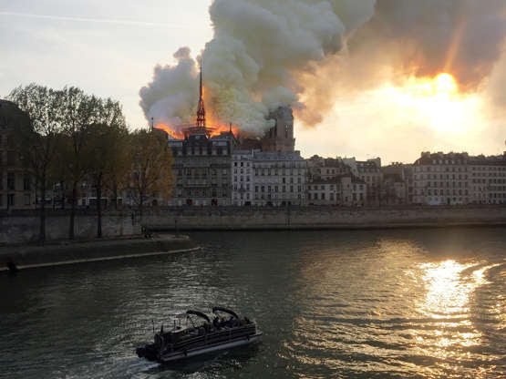 Slide 25 of 31: Smoke billows from the Notre Dame Cathedral after a fire broke out, in Paris, France, April 15, 2019. REUTERS/Julie Carriat - RC19FB4834C0