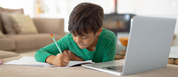 Boy writing at home