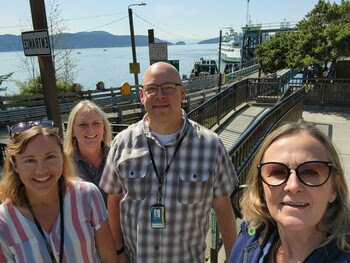 Four people posing for a selfie at Lopez Island terminal