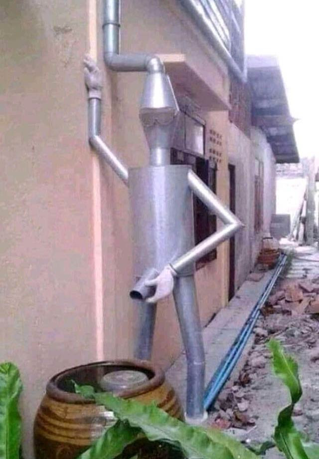 31 Funny Memes & Crazy Pics of Twisted Humor ~ Tin Man rain downspout statue peeing in barrel