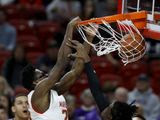 Maryland forward Jalen Smith, left, dunks on Northwestern forward Jared Jones during the first half of an NCAA college basketball game, Tuesday, Feb. 18, 2020, in College Park, Md. (AP Photo/Julio Cortez)