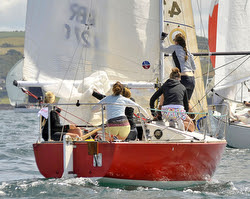 J/24 Poole girls sailing team- setting spinnaker