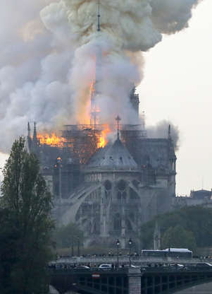 Slide 31 of 31: Smokes ascends as flames rise during a fire at the landmark Notre-Dame Cathedral in central Paris on April 15, 2019 afternoon, potentially involving renovation works being carried out at the site, the fire service said. (Photo by FRANCOIS GUILLOT / AFP) (Photo credit should read FRANCOIS GUILLOT/AFP/Getty Images)