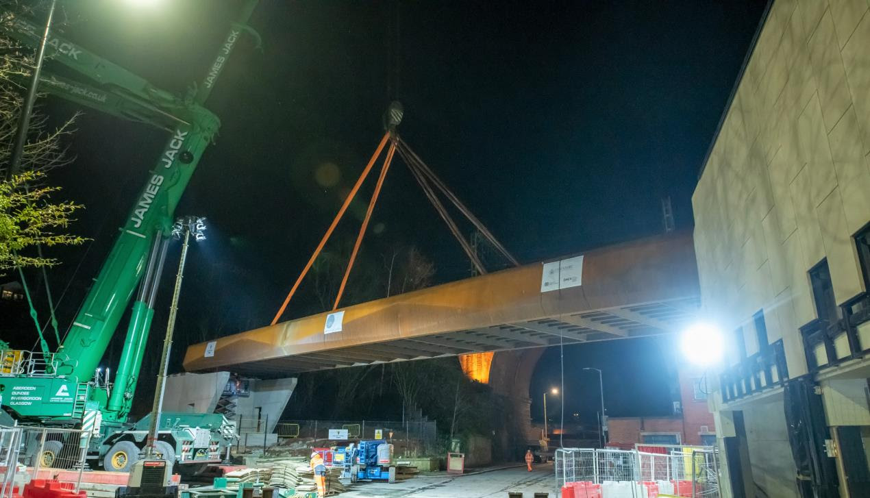 The cycling and walking bridge is manourvered into position over Daw Bank, Stockport 
