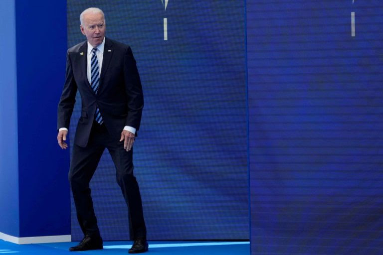 Joe Biden crouches 
