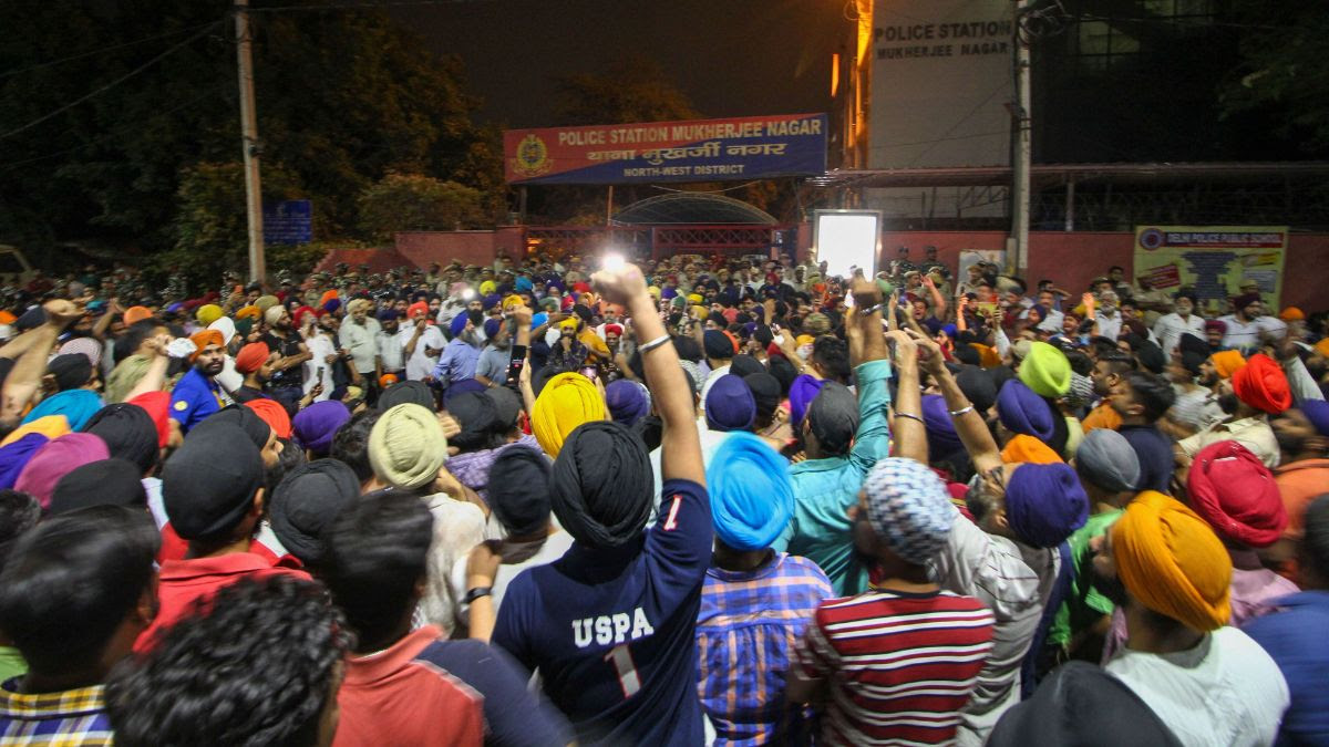 Protestors gather outside Mukherjee Nagar Police Station. (Photo: PTI)