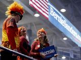 Members of the audience in costume stand as they hear the band Sunflower Bean perform before Democratic presidential candidate Sen. Bernie Sanders, I-Vt., speaks at at campaign stop at the Whittemore Center Arena at the University of New Hampshire, Monday, Feb. 10, 2020, in Durham, N.H. (AP Photo/Andrew Harnik)