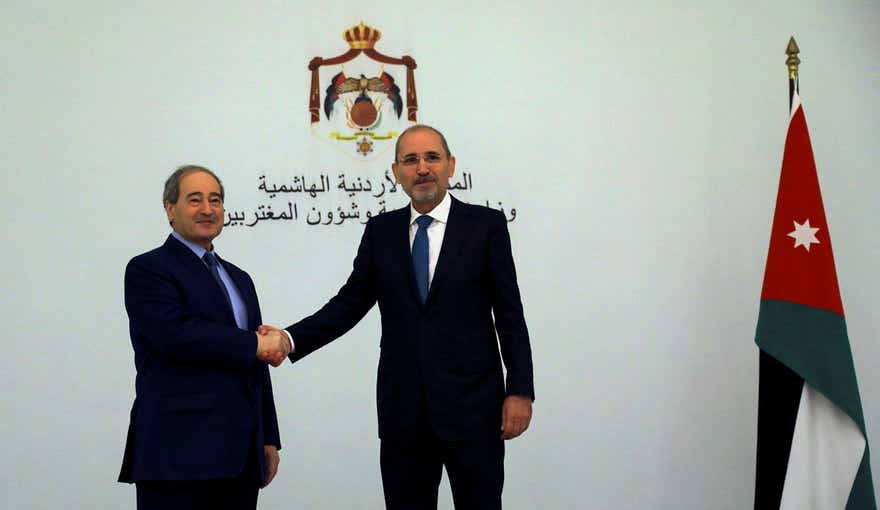 Jordan's Foreign Minister Ayman Safadi shakes hands with Syria's Foreign Minister Faisal Mekdad, before the start of the meeting of Arab foreign ministers in Amman, Jordan May 1, 2023