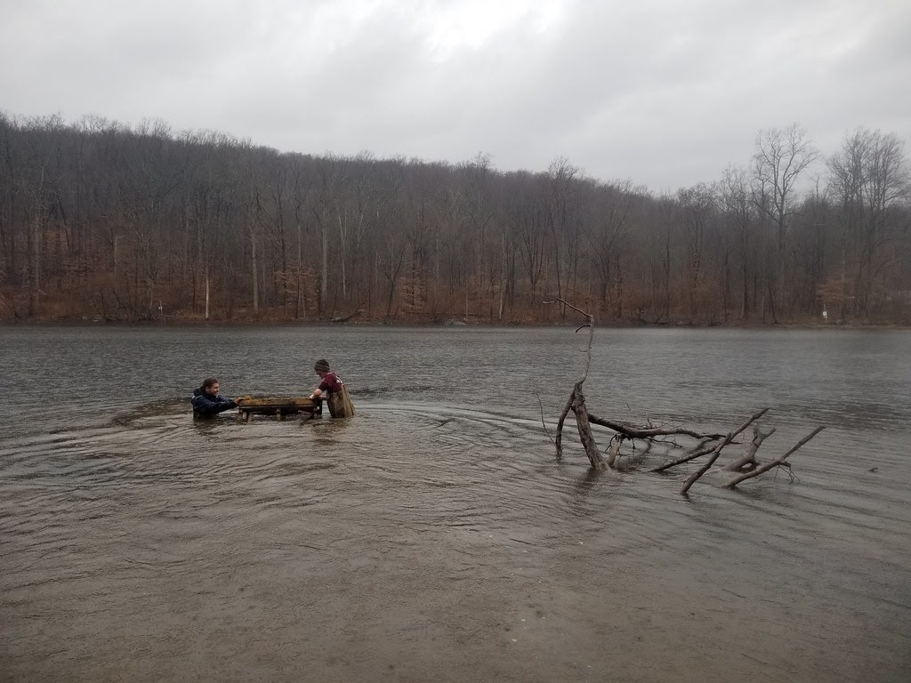 Photo of staff deploying fish habitat made from recycled materials