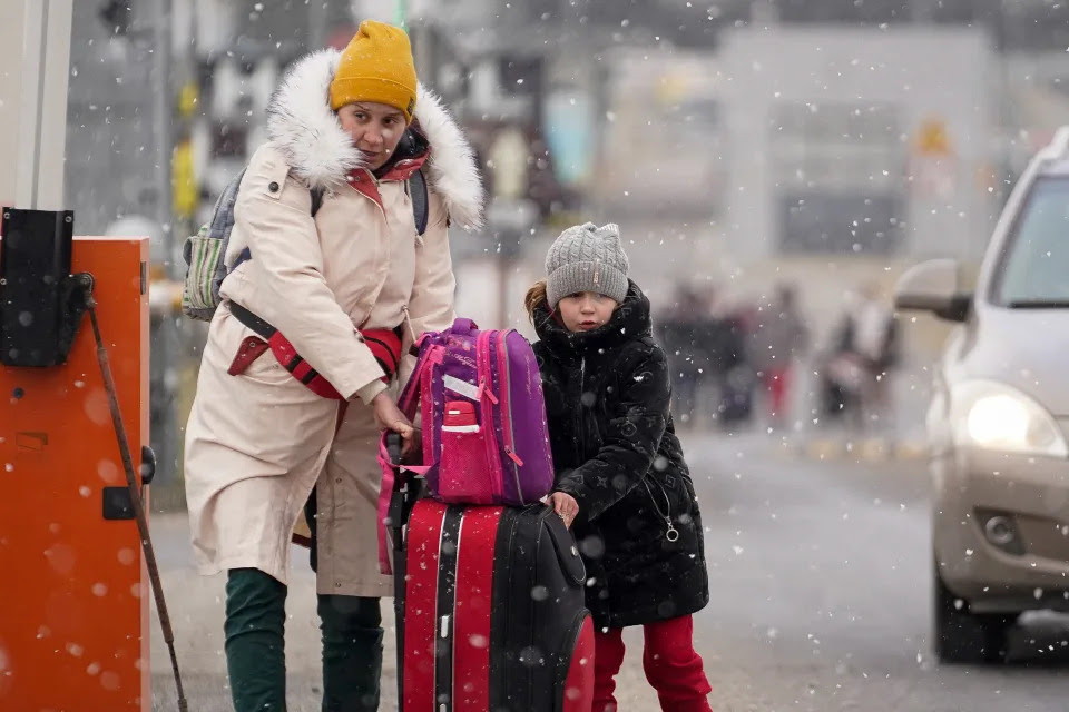 A woman and her daughter fleeing the Russian invasion in Ukraine.