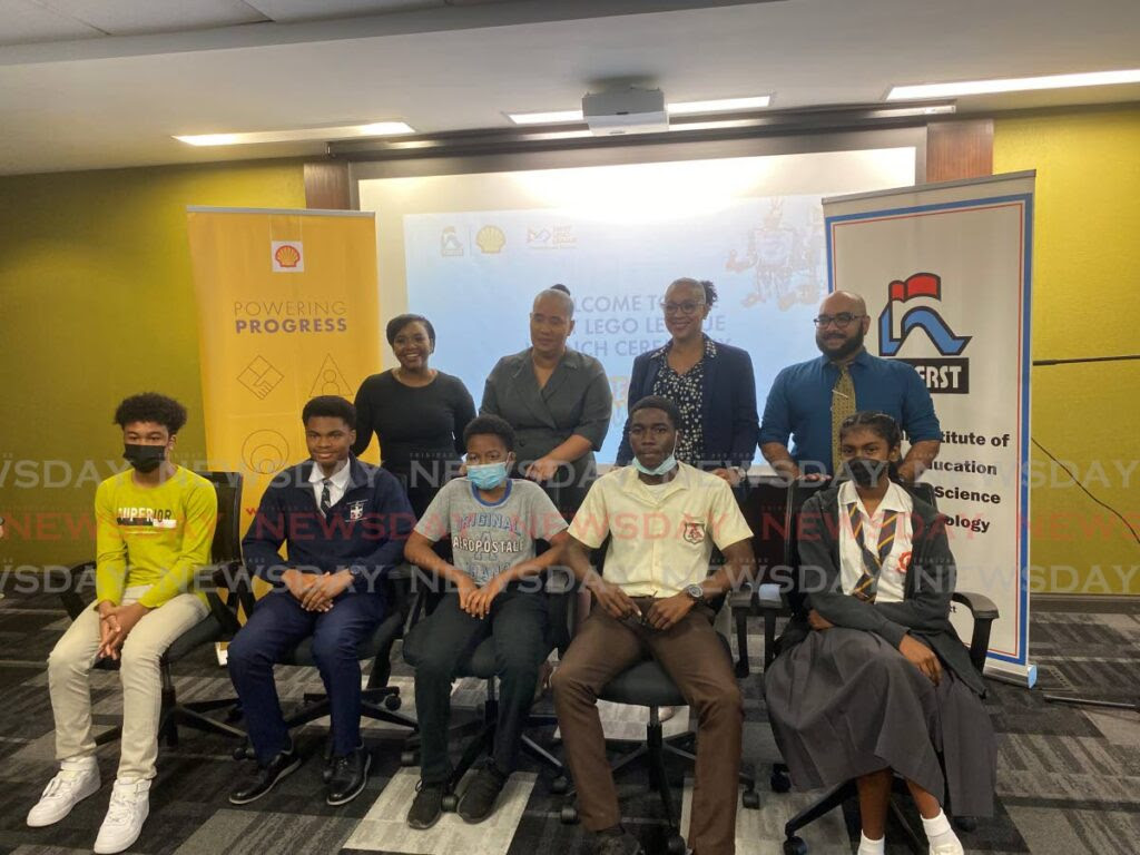 Shell's Ryssa Brathwaite, left, Minister in the Ministry of Education Lisa Morris-Julian, second from left, NIHERST's Lovaan Superville and curriculum officer Vishal Ramjattan with schoolchildren at the launch of the First Lego League at the Ministry of Education, Port of Spain on Wednesday. Photo by Nicholas Maraj