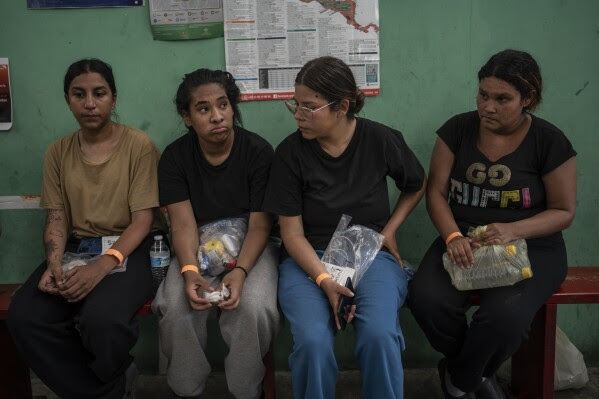 Venezuelan migrant Yeneska Garcia, second from left, sits with other migrants at the Peace Oasis of the Holy Spirit Amparito shelter in Villahermosa, Mexico, Friday, June 7, 2024. "I would rather cross the Darien Gap 10,000 times than cross Mexico once," Garcia said. (AP Photo/Felix Marquez)
