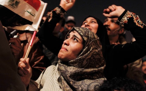 An Egyptian woman cries as she celebrates the news of the resignation of President Hosni Mubarak