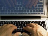 In this Wednesday, Feb. 27, 2013, photo illustration, hands type on a computer keyboard in Los Angeles. (AP Photo/Damian Dovarganes, File)