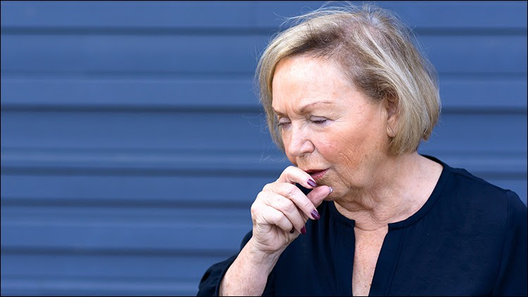The figure shows an older adult woman coughing.