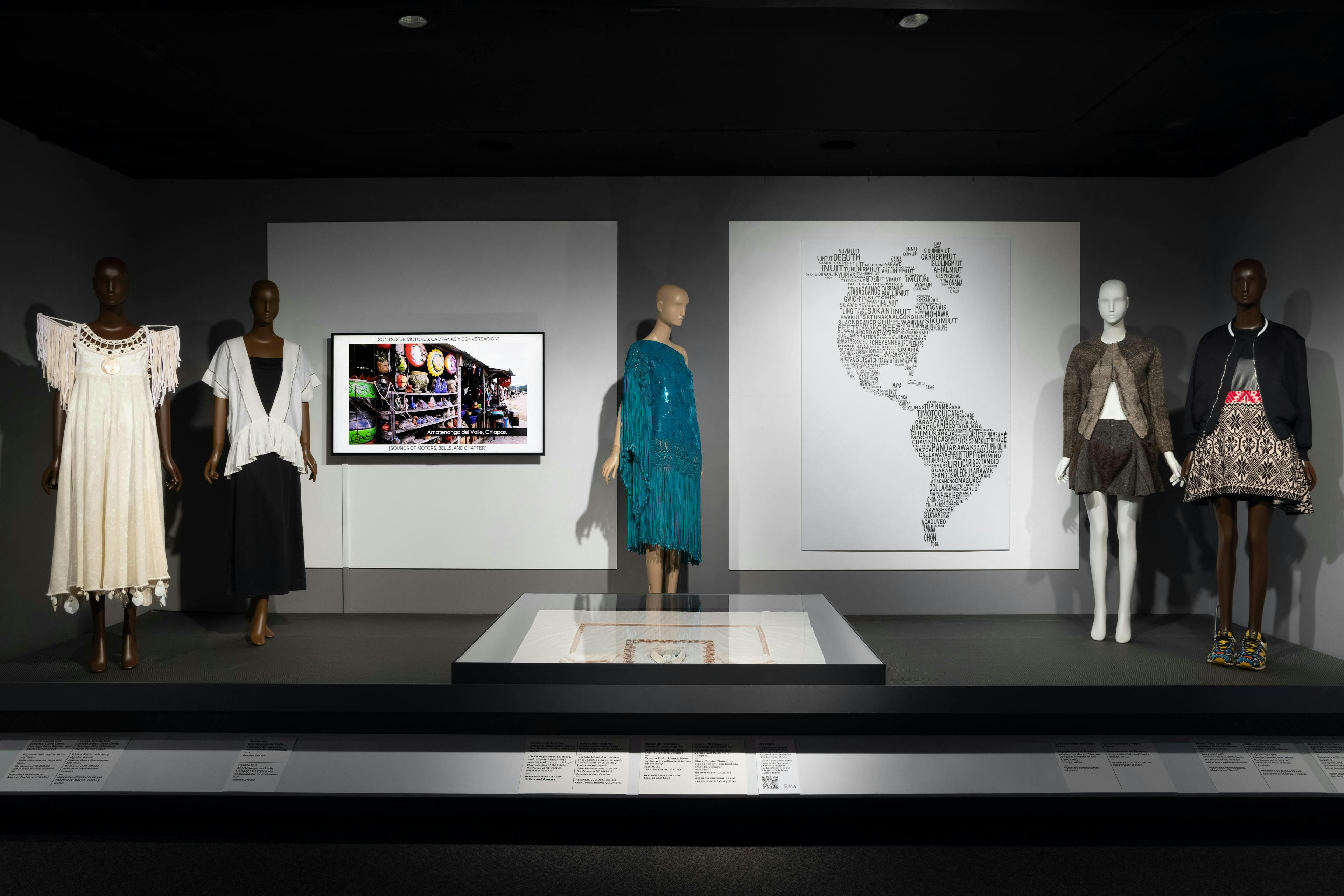 ¡moda hoy! latin american and latinx fashion design today exhibition installation fashion & textile history gallery the museum at fit person electronics screen clothing coat footwear shoe hardware monitor fashion