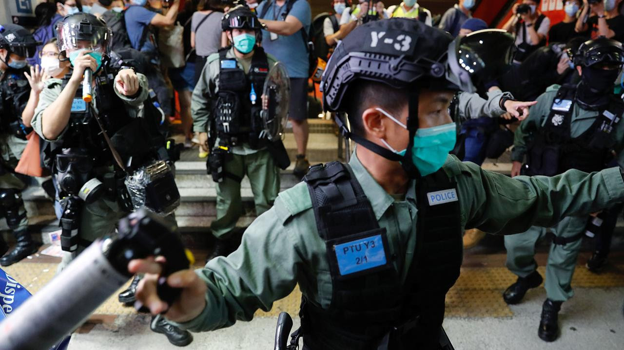 Riot police disperse pro-democracy demonstrators as they take part a singing song protest at Mong Kok, in Hong Kong, China June 12, 2020.