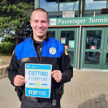 Photo of trooper holding up a sign about line cutting