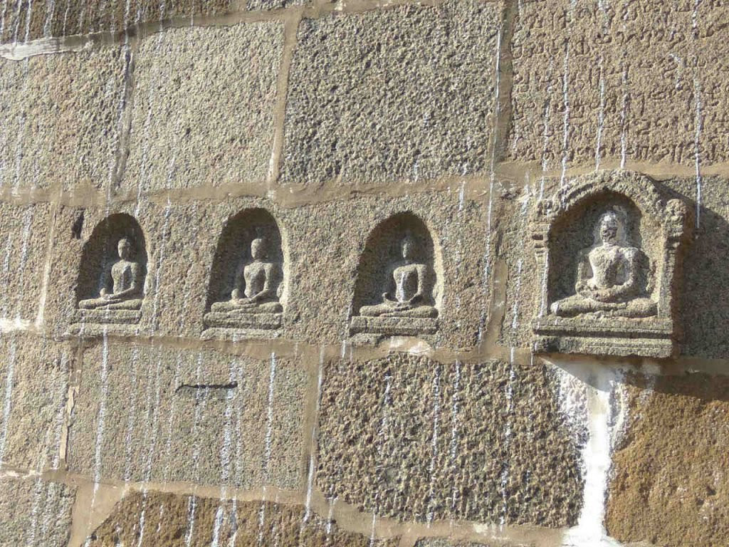 Buddha images in the compound wall of Ekambareswarar Temple, Kanchi.