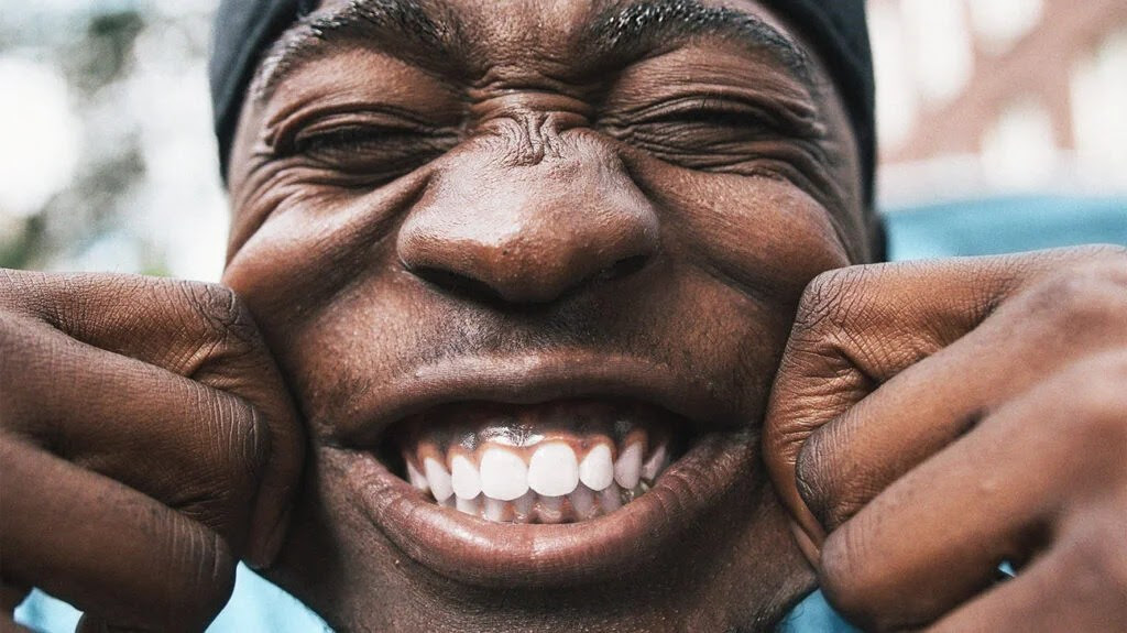 Close up of a person laughing and smiling