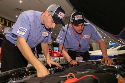National Automotive Technology Competition Winners Andrew Stuart (left) and Evan Sennefelder under the hood at the 2018 National Automotive Technology Competition.