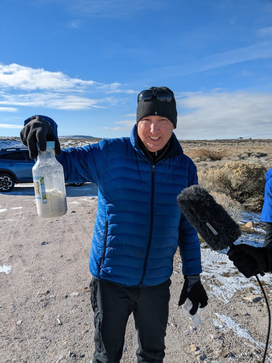 Kevin
                      Perry demonstrating the Great Salt Lake’s
                      salinity. He’s holding a bottle he filled with
                      lake water, which the liquid then evaporated from,
                      leaving it half-full of salt crystals. The Great
                      Salt Lake can get up to eight times saltier than
                      the ocean, and its salinity is climbing.