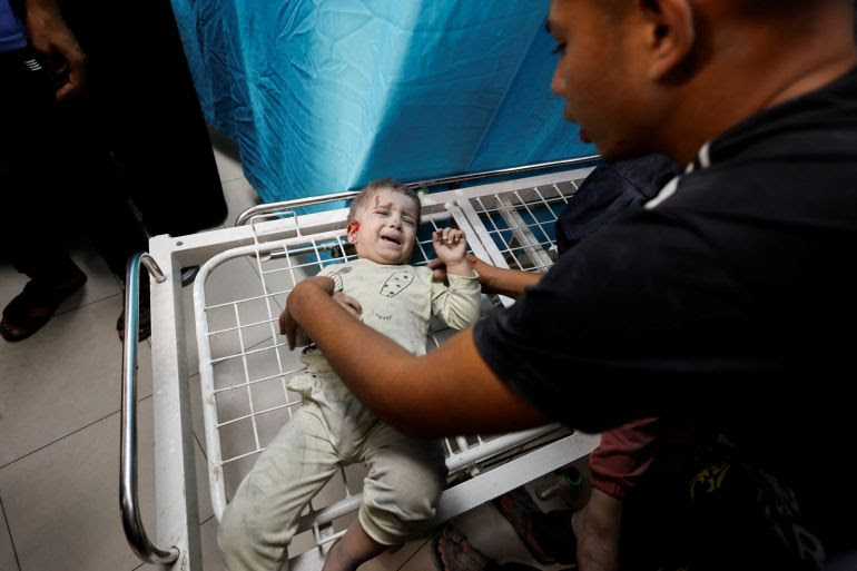 A Palestinian child wounded in Israeli strikes waits to receive treatment at Nasser hospital in Khan Younis in the southern Gaza Strip