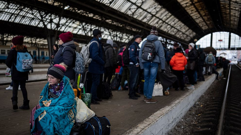 Passengers wait at the platform inside Lviv railway station, Sunday, Feb. 27, 2022, in Lviv, west Ukraine. (AP Photo/Bernat Armangue)