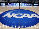 In this March 18, 2015, file photo, the NCAA logo is displayed at center court as work continues at The Consol Energy Center in Pittsburgh, for the NCAA college basketball tournament. The NCAA Board of Directors is expected to greenlight one of the biggest changes in the history of college athletics when it clears the way for athletes to start earning money based on their fame and celebrity without fear of endangering their eligibility or putting their school in jeopardy of violating amateurism rules that have stood for decades. (AP Photo/Keith Srakocic, File)