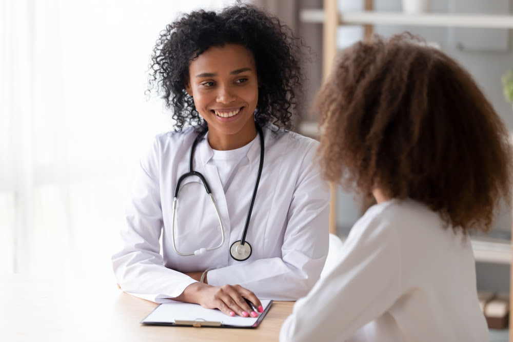 female doctor talking with female patient