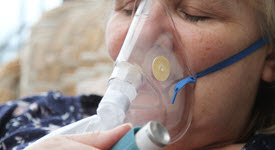 young girl with oxygen mask