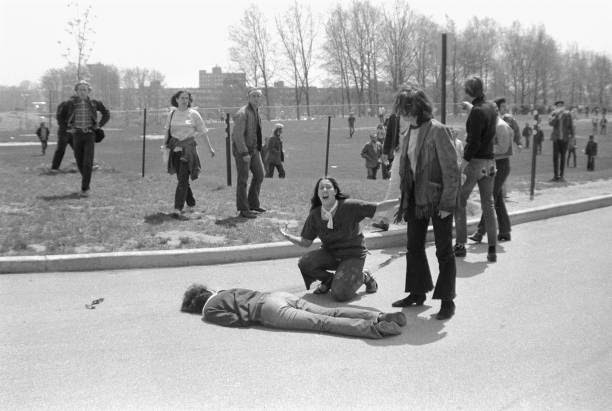 Teenager Mary Ann Vecchio screams as she kneels over the body of Kent State University student Jeffrey Miller who had been shot during an antiwar...