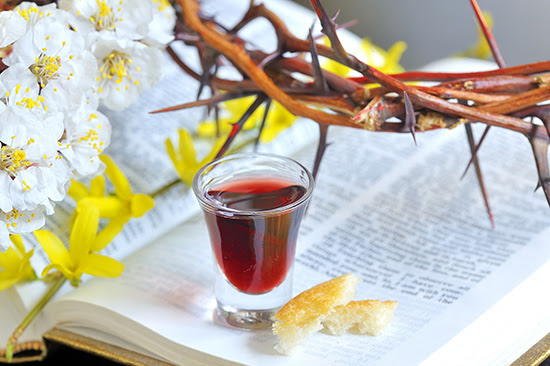Bible, glass of wine, crown of thorns and
              flowers
